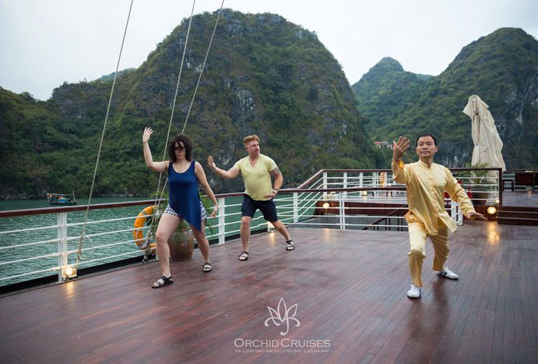 Do Tai Chi on Orchid Cruises Halong Bay- ລ່ອງເຮືອຮາລອງຫຼູຫຼາ